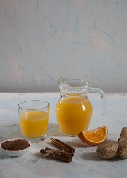 Orange Juice Ginger Glass Jug Glass Cinnamon Sticks Light Background — Stock Photo, Image