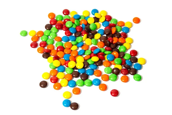 Kleurrijke chocolade MMS in en uit focus op witte achtergrond — Stockfoto