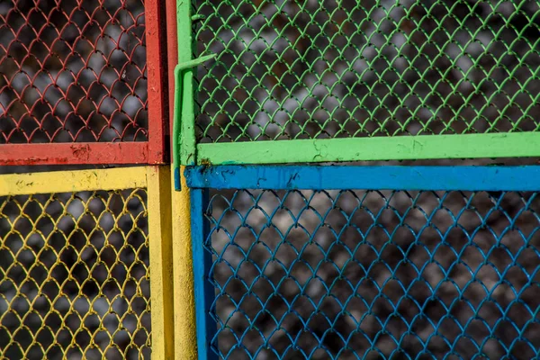 Grunge texture with colored metal mesh fence background