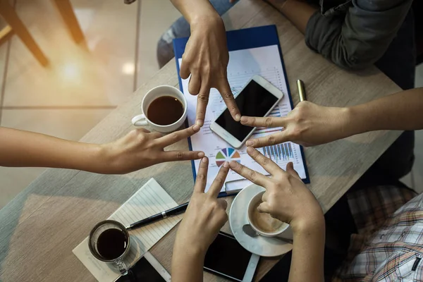 The finger star shape from teamwork,the collaborator concept,unired hands team,successful and unity of team.vintage warm light tone,blurry light around.