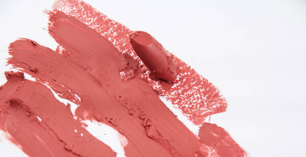 Closeup the smudged lipstick on background.Matt beige color lipstice.show texture and color of product