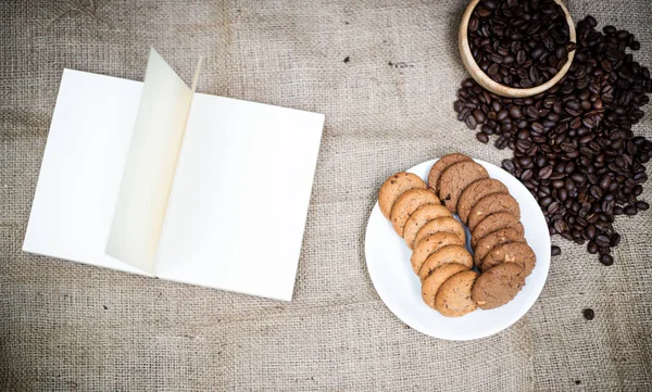 Opened Book Put Dish Cookies Roasted Coffee Beans Hemp Cloth — Stock Photo, Image