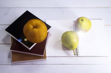 The chinese Pear put on timber board,blurry light design background,Lens flare effect