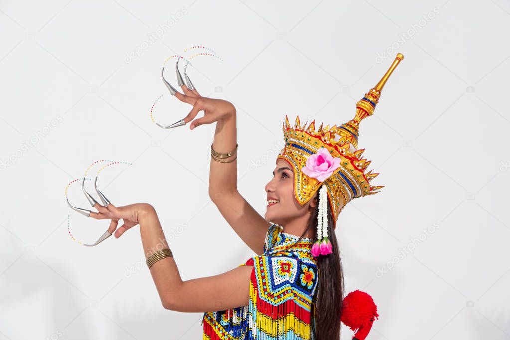 The beautiful woman wearing Thai southern folk dancing costume,made from colorful bead,and the headdress on her head,raise hands up in the air,touch finger together for perform Thai folk dance