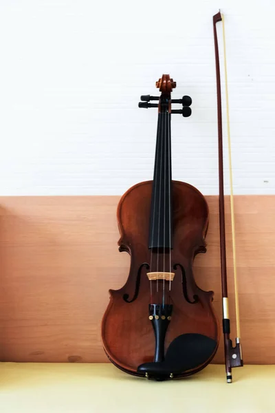 The classic violin and bow put on wooden desk,show detail of acoustic instrument