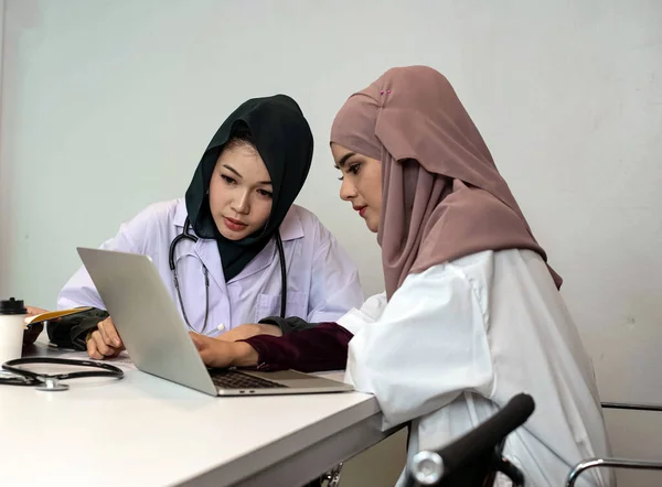Two female doctors working  together,consult about patient case,at hospital