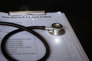 Stetoskop başkanı bulanık sigorta talep formunu taktı, lensler alev aldı, bulanık ışık yandı.