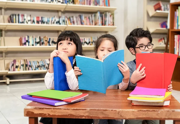 Three Children Reading Book Together School Interested Feeling Blurry Light — стоковое фото