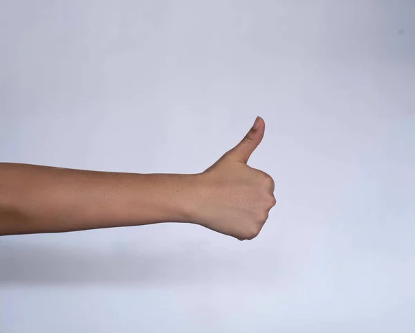 Human hand thump up on white background,sign and symbol of positive and good thing,body language