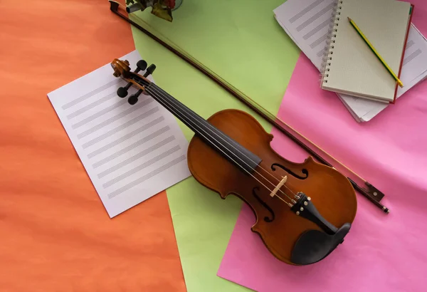 Violin and bow put beside  blank note sheet and book,prepare for practice