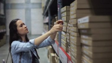 Hırdavatçıdan ev tadilatı için mal alan kadın müşteri. Depodan bir şey almak isteyen bir kadın.