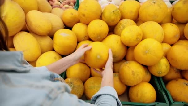 La femme choisit les fruits au supermarché. Une jeune fille achète de la nourriture pour un régime végétalien. Aliments sains, légumes jaune vif au magasin. — Video