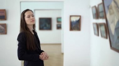 Zarif Güzel Kadın Sanat Açılış Resepsiyonunda Galeride Tablolara Bakar. Modern Sanatlar Müzesi 'nde resimler. Şehir Sanat Galerisindeki Serginin Sanat Resimleri. 