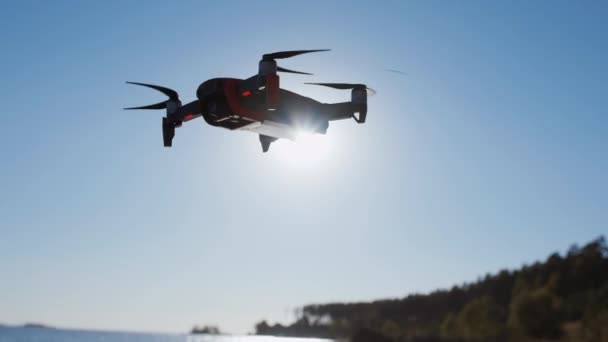 Close-up de um helicóptero, atirando perto do mar no outono. Drone voa perto do mar, tira fotos e vídeos. Voando e filmando com câmera quadricóptero . — Vídeo de Stock