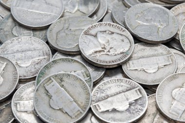Pile of nickles scattered on top of each other clipart