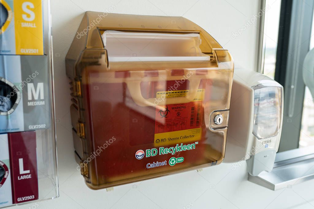 Portland, OR / USA - August 17 2018: Medical box for storage and disposal of used needles and other sharp bio-hazardous objects.