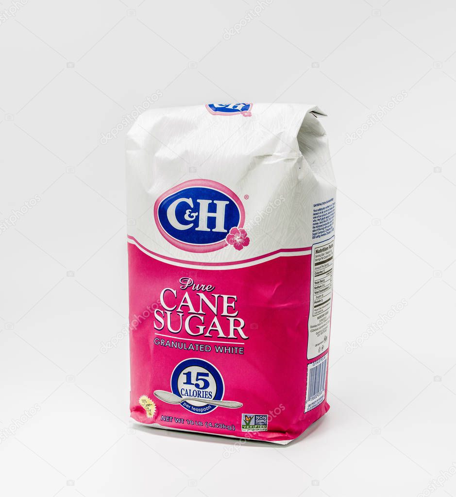 Portland, OR / USA - October 11 2018: C&H  Pure white granulated cane sugar in a big paper bag, isolated on light background. Produced by Domino foods.