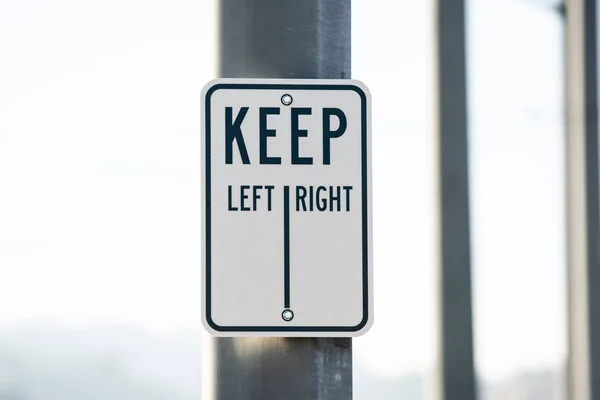 Keep left right sign on the metal pole
