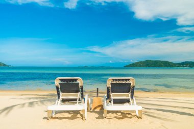 Güzel tropikal plaj ve Hindistan cevizi hurma ağacı ve Cennet Adası sandalyede denize sıfır