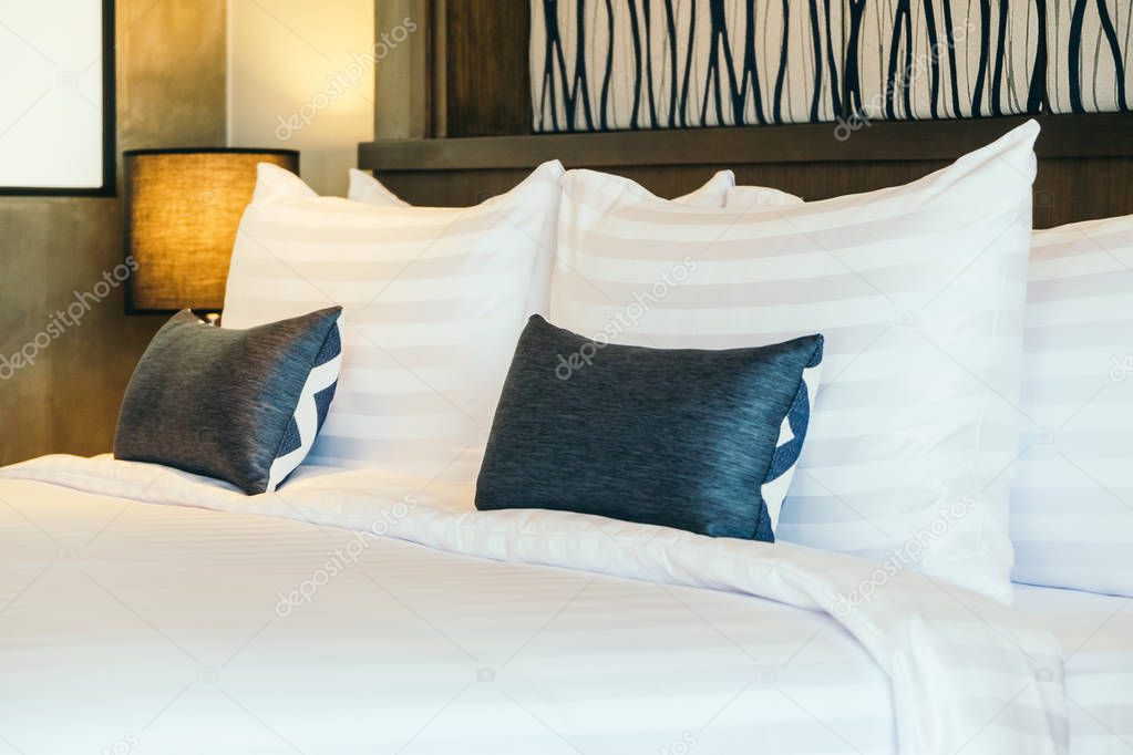 Comfortable pillow on bed decoration in hotel bedroom interior