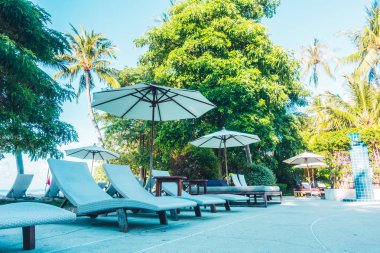 Güzel lüks otel ve tatil seyahat ve tatil için sandalye ve şemsiye ile açık yüzme havuzu