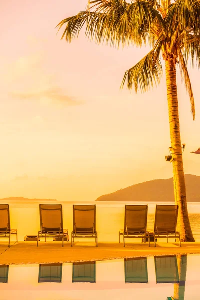 Şemsiye ve lüks otel ve gündoğumu zaman seyahat ve tatil için Resort'ta yüzme havuzu etrafında sandalye ile güzel açık görünüm