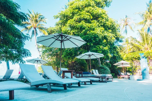 Güzel lüks otel ve tatil seyahat ve tatil için sandalye ve şemsiye ile açık yüzme havuzu