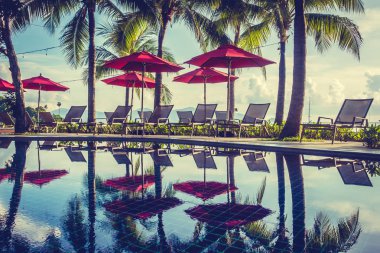 Güzel lüks otel ve tatil seyahat ve tatil için sandalye ve şemsiye ile açık yüzme havuzu