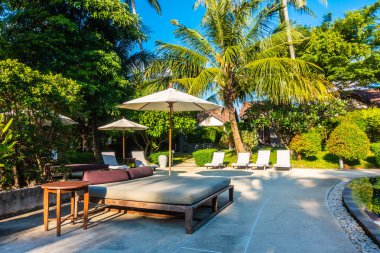 Güzel lüks otel ve tatil seyahat ve tatil için sandalye ve şemsiye ile açık yüzme havuzu