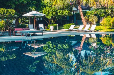 Güzel lüks otel ve tatil seyahat ve tatil için sandalye ve şemsiye ile açık yüzme havuzu