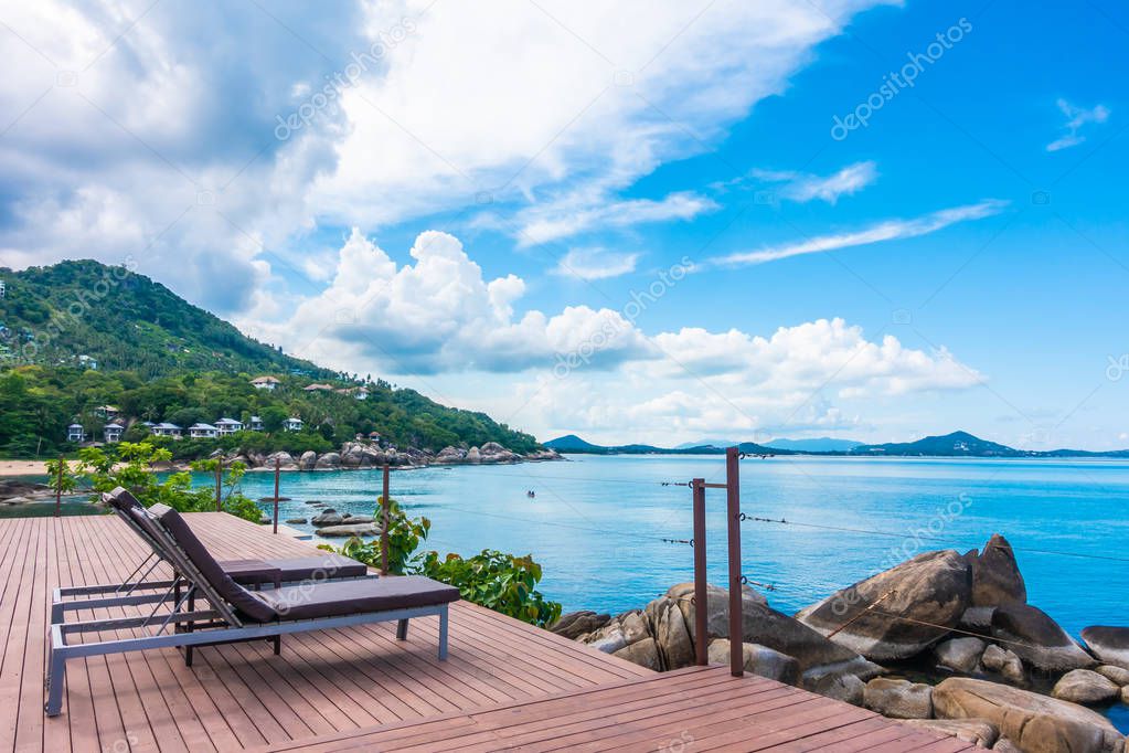 Beautiful tropical sea ocean and blue sky background with bed on patio balcony for travel and vacation