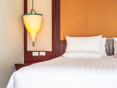 Otel yatak odasında ışık lamba dekorasyonu ile yatakta rahat yastık