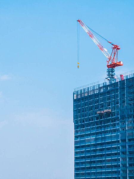 Crane building under construction exterior with sky background