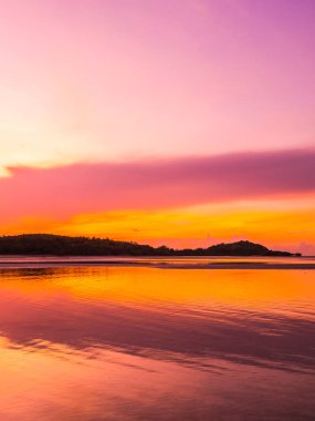 Güzel tropikal plaj deniz ve okyanus ile Hindistan cevizi hurma ağacı gündoğumu zaman seyahat ve tatil için