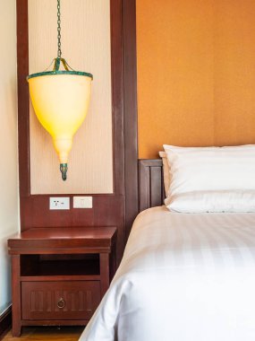 Otel yatak odasında ışık lamba dekorasyonu ile yatakta rahat yastık