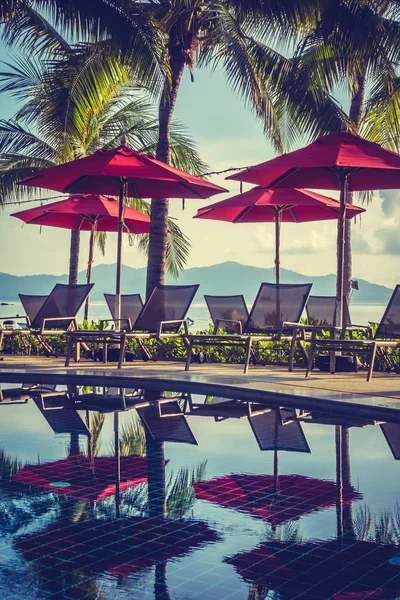 Güzel lüks otel ve tatil seyahat ve tatil için sandalye ve şemsiye ile açık yüzme havuzu