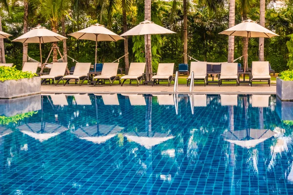 Güzel lüks otel ve tatil seyahat ve tatil için sandalye ve şemsiye ile açık yüzme havuzu