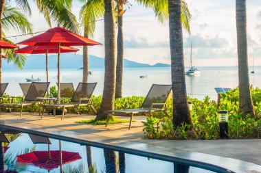 Güzel lüks otel ve tatil seyahat ve tatil için sandalye ve şemsiye ile açık yüzme havuzu