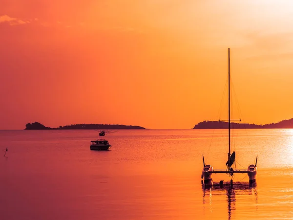 Beautiful tropical sea and ocean with sailboat or yatch at sunrise time