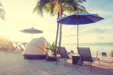 Şemsiye ve lüks otel ve gündoğumu zaman seyahat ve tatil için Resort'ta yüzme havuzu etrafında sandalye ile güzel açık görünüm