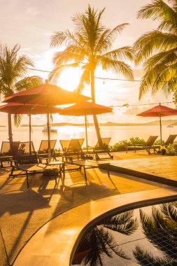 Güzel lüks otel ve tatil seyahat ve tatil için sandalye ve şemsiye ile açık yüzme havuzu