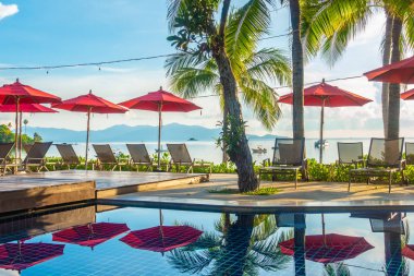 Güzel lüks otel ve tatil seyahat ve tatil için sandalye ve şemsiye ile açık yüzme havuzu