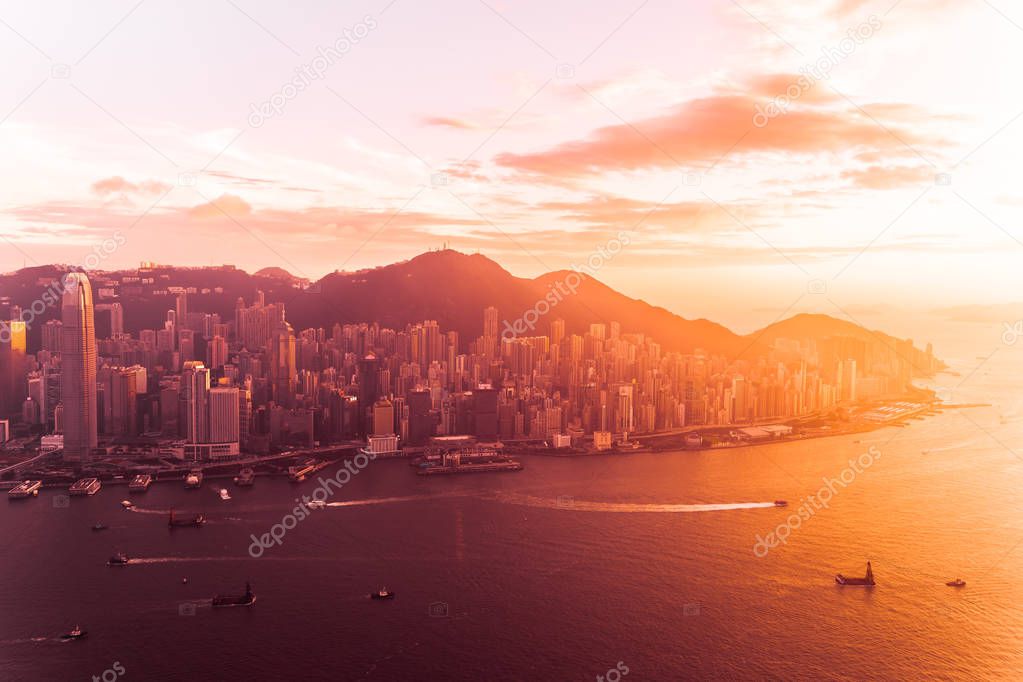 Beautiful colorful sunset in hong kong city skyline with sea and ocean bay