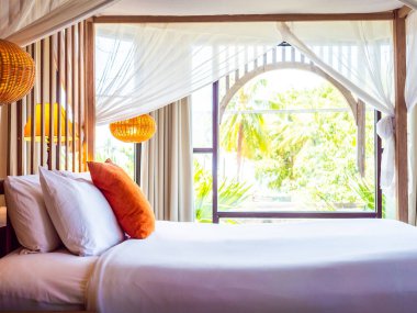 Otel yatak odasında ışık lamba dekorasyonu ile yatakta rahat yastık