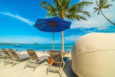 Güzel tropikal plaj ve Hindistan cevizi hurma ağacı ve şemsiye ve Cennet Adası tatil tatil için sandalyeye denize sıfır