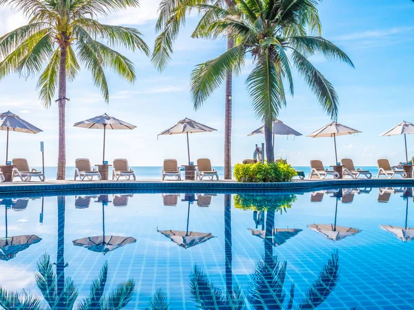 雨伞和椅子周围的豪华室外游泳池在酒店和度假村度假和旅游 — 图库照片