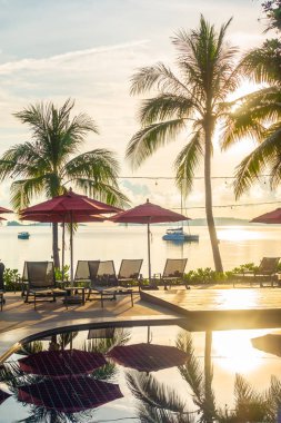 Güzel lüks otel ve tatil seyahat ve tatil için sandalye ve şemsiye ile açık yüzme havuzu