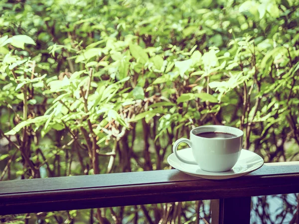 Outdoor patio with beautiful nature view and white coffee cup for relax