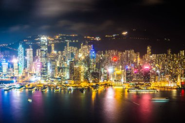 Hong Kong şehrinin dış şehir manzarası geceleri gökyüzüne yükseliyor.