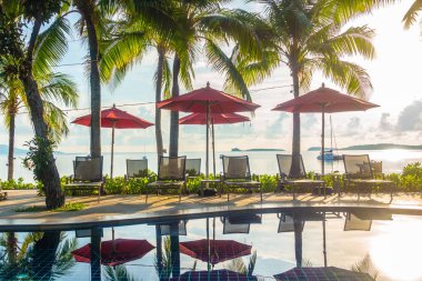 Güzel lüks otel ve tatil seyahat ve tatil için sandalye ve şemsiye ile açık yüzme havuzu